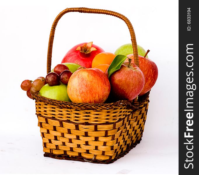 Basket with different fruits, such as grapes and apples. Basket with different fruits, such as grapes and apples