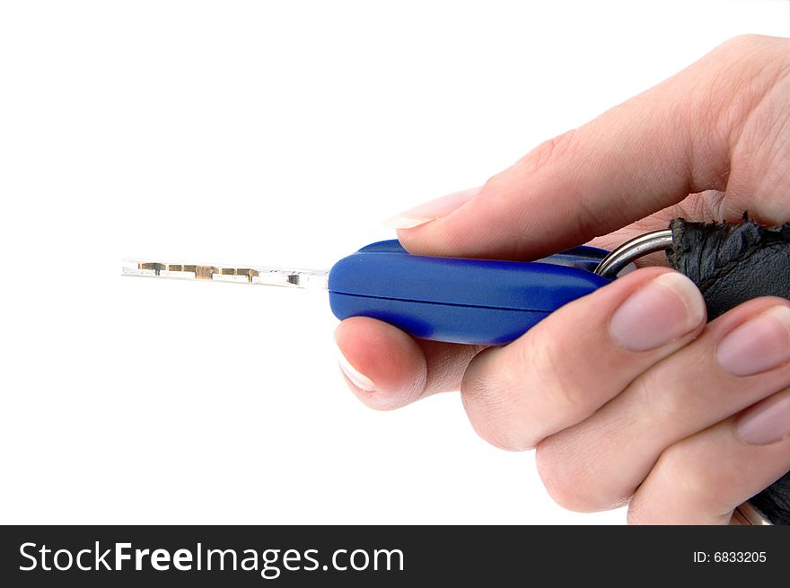 An isolated image of a hand pressing a button on a vehicle key fob. An isolated image of a hand pressing a button on a vehicle key fob