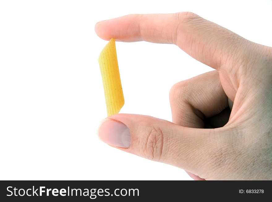 An Isolated image of hand delicately holding one piece of pasta. An Isolated image of hand delicately holding one piece of pasta