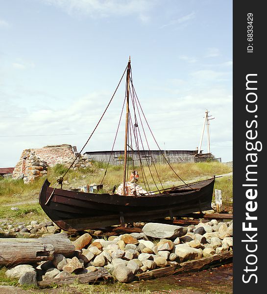 Old fishing sailing boat ashore. Old fishing sailing boat ashore