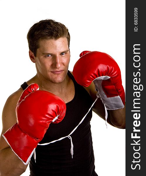 A boxer in workout clothes and red boxing gloves isolated on white. A boxer in workout clothes and red boxing gloves isolated on white