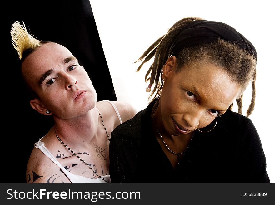 Portrait of white man with mohawk and black woman with dreadlocks. Portrait of white man with mohawk and black woman with dreadlocks