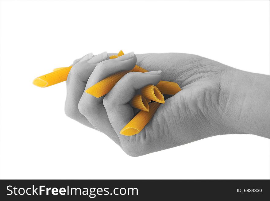 An isolated image of a black and white hand grabbing some penne pasta. An isolated image of a black and white hand grabbing some penne pasta