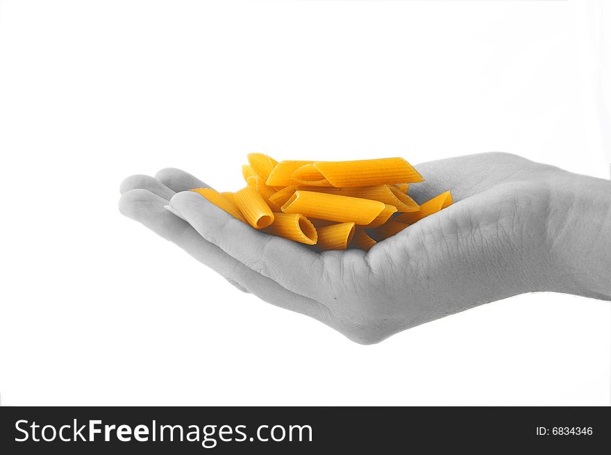 An isolated image of a black and white hand holding some penne pasta. An isolated image of a black and white hand holding some penne pasta