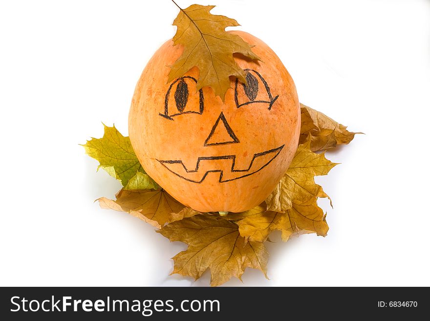 Halloween pumpkin with autumn leaf on white