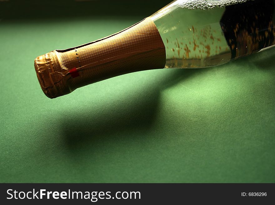 Bottle of white wine in green background
