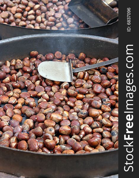 image of a pile of chestnuts in a market. image of a pile of chestnuts in a market