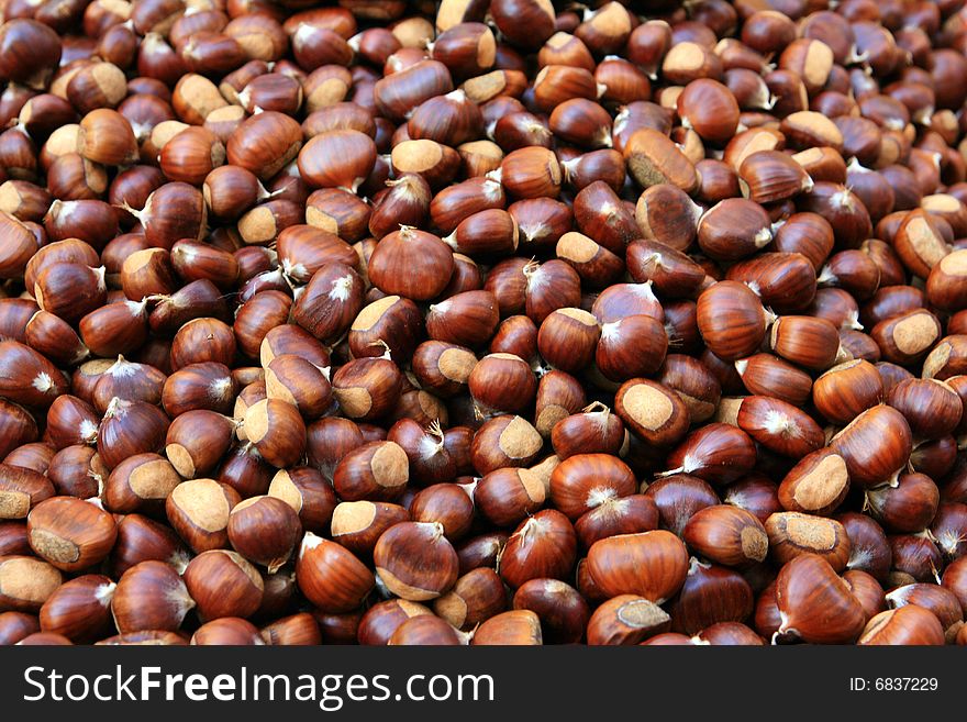 Horizontal image of a pile of chestnuts in a market. Horizontal image of a pile of chestnuts in a market