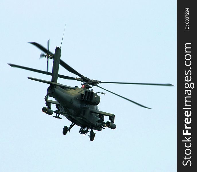 Back side of an Army green helicopter in flight