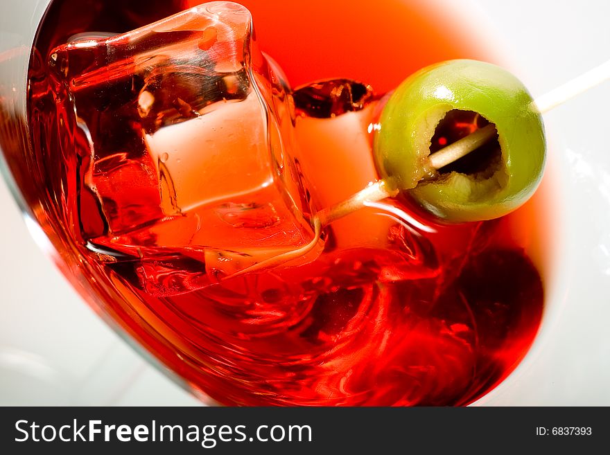 Close-up of olive on a martini glass with ice. Close-up of olive on a martini glass with ice