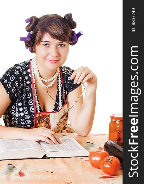 Smiling housewife sitting by the table with glasses