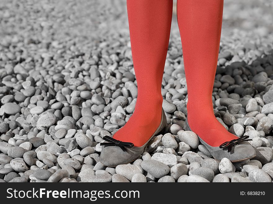 Two womens legs dressing in red tights. Two womens legs dressing in red tights