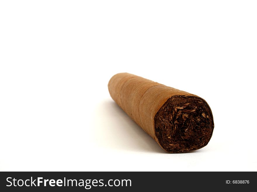 Hand rolled cigar on a white background