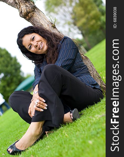 Latina Woman  happy smiling and  relaxing outdoors in a park. Latina Woman  happy smiling and  relaxing outdoors in a park