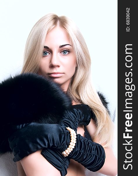 Portrait of a beautiful young lady in black fur and gloves. Portrait of a beautiful young lady in black fur and gloves