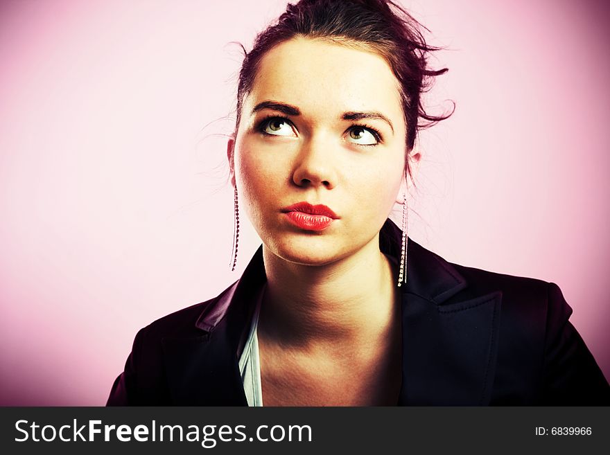 Young beautiful girl dreaming about... On pink background. Young beautiful girl dreaming about... On pink background.