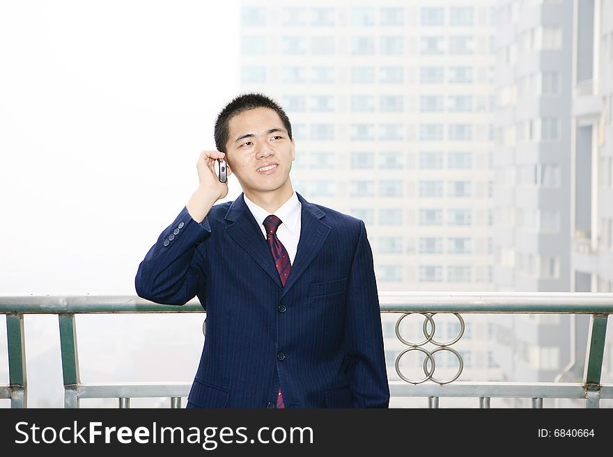 Young asian business man holding mobile phone