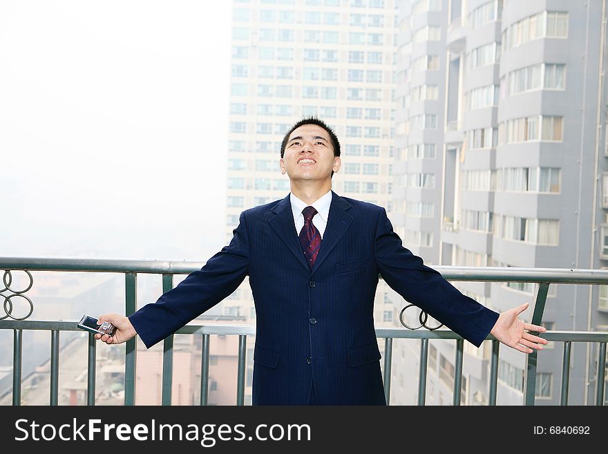 A young asian standing before building. A young asian standing before building