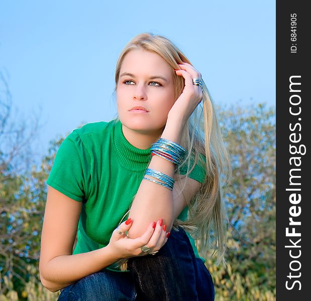 Beautiful blondy woman posing on autumn sunset