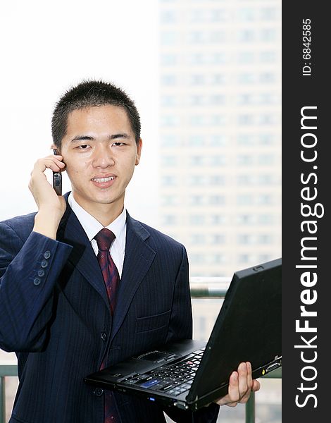 Businessman holding laptop computer