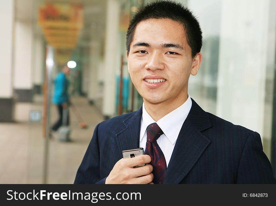 A young asian standing in office building. A young asian standing in office building