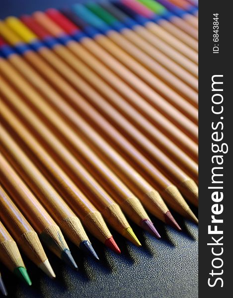 Colouring pencils laid out against a black surface. Colouring pencils laid out against a black surface.