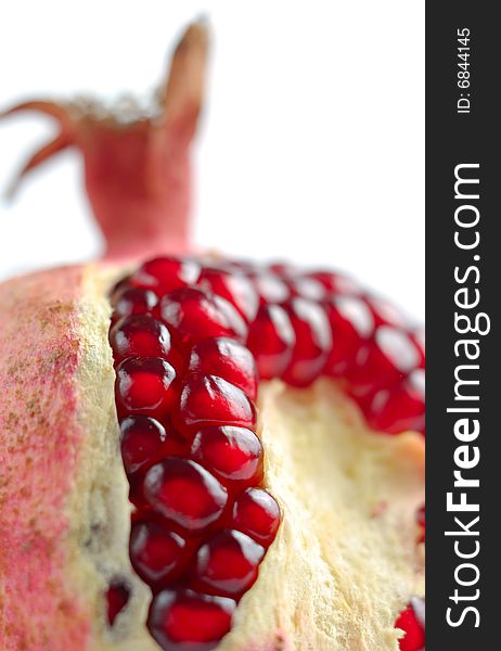 Peeled juicy pomegranate isolated over white background