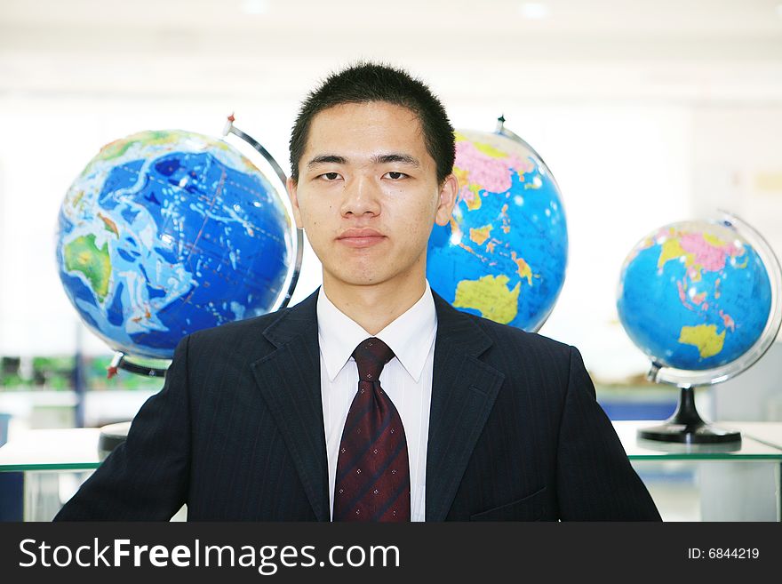 Young chinese business with tellurion. Young chinese business with tellurion