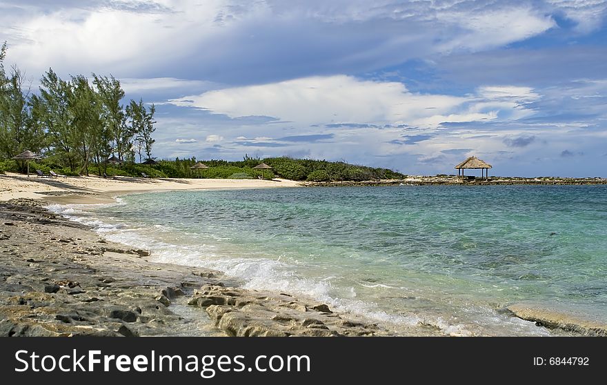 Tropical shoreline with clear green water and rocky shore. Tropical shoreline with clear green water and rocky shore.