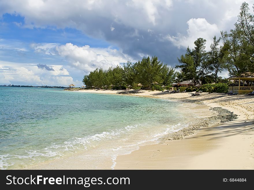 Beautiful stretch of tropical beach with clear green and blue water. Beautiful stretch of tropical beach with clear green and blue water.