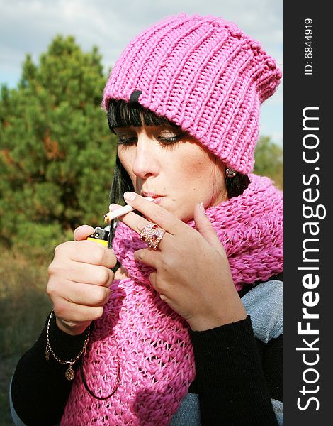 A woman smoking a cigarette.