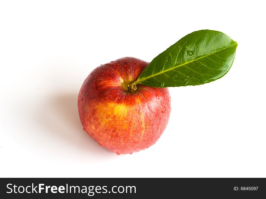Bright isolated red apple with green leaf. Bright isolated red apple with green leaf