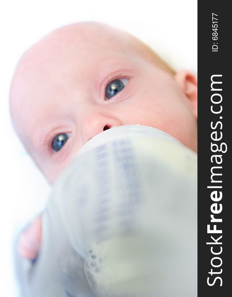 Newborn baby eating from  milk bottle