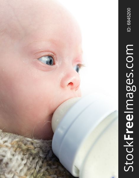 Newborn baby eating from  milk bottle