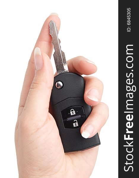 Keys from the car in a female hand. It is isolated.