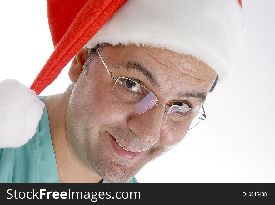 Doctor wearing christmas hat against white background