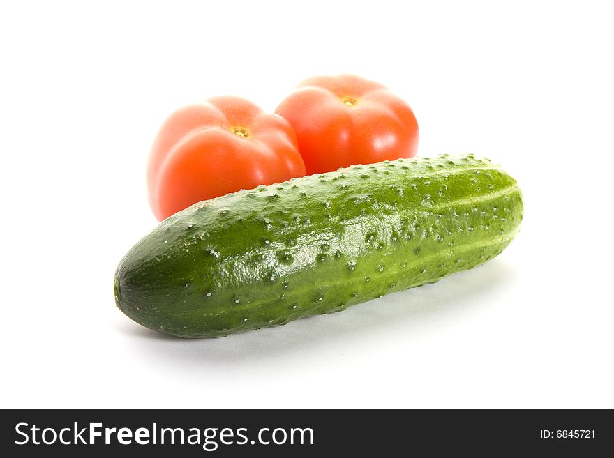 Ripe cucumber and two tomatos isolated on white