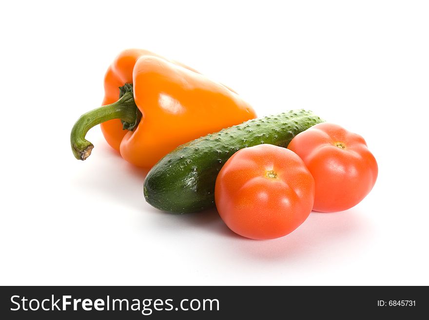Orange pepper, cucumber and two tomatos isolated on white background