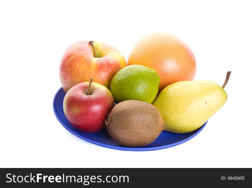 Few fruits on blue plate isolated on white