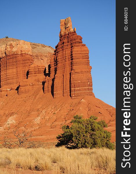 Rock Tower And Field In Utah