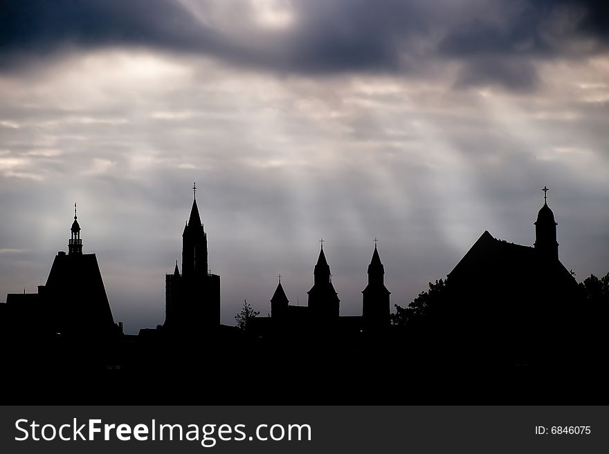 Dark silhouettes of cathedrals against evening skies in Maastricht, Netherlands. Dark silhouettes of cathedrals against evening skies in Maastricht, Netherlands.