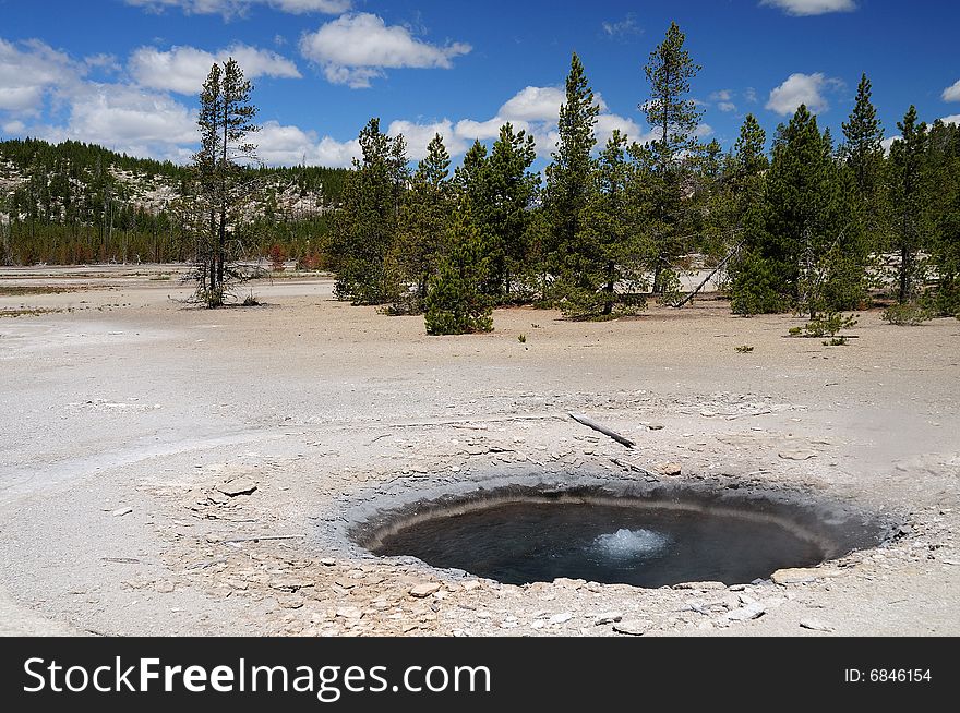 Volcanic hot pool in yellowstone national park on a beautifull spring day. Volcanic hot pool in yellowstone national park on a beautifull spring day.