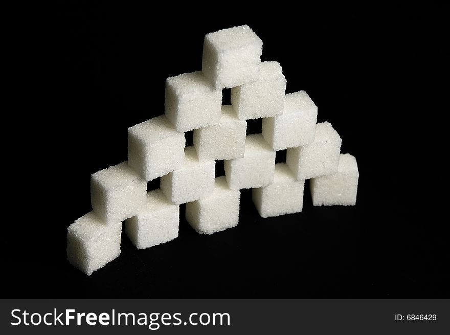 Sugar cubes isolated on black