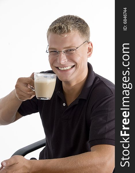 Pleased man taking tea on an isolated white background