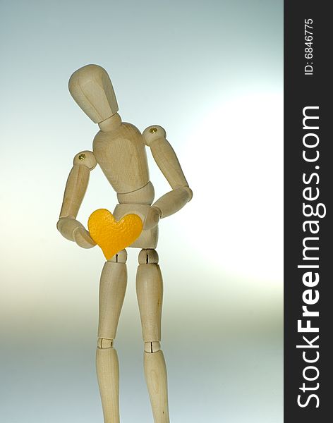 A shot of a jointed Doll showing a heart. A shot of a jointed Doll showing a heart