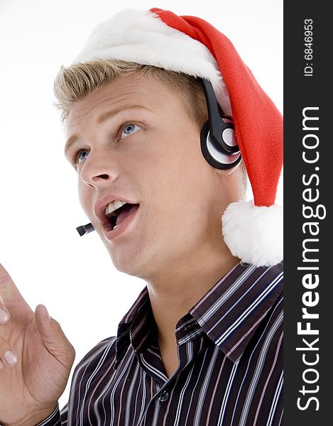 Close up of man interacting through headset wearing santa hat isolated with white  background