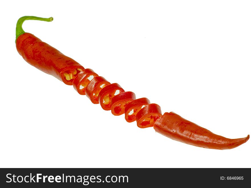 A shot of a sliced isolated chili on white. A shot of a sliced isolated chili on white