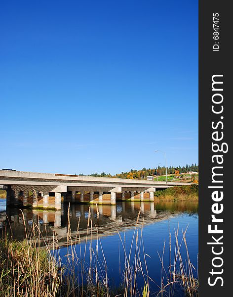 Highway Bridge over calm river. Highway Bridge over calm river