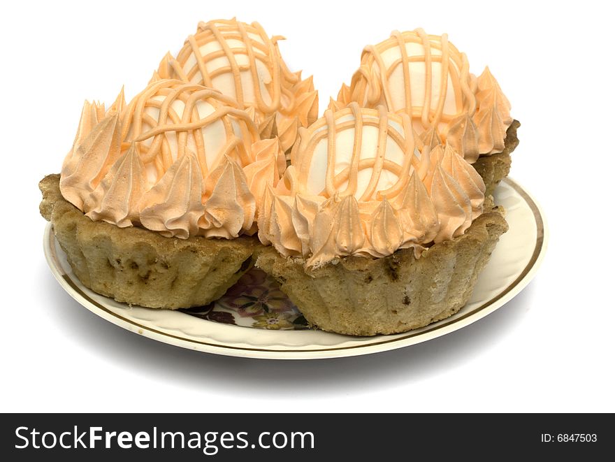 Four cake with a zephyr on a plate isolated on a white background