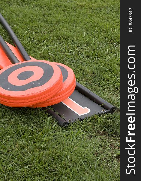 Football lineman set, with down marker and chain poles, laying abandoned on the ground. Football lineman set, with down marker and chain poles, laying abandoned on the ground.